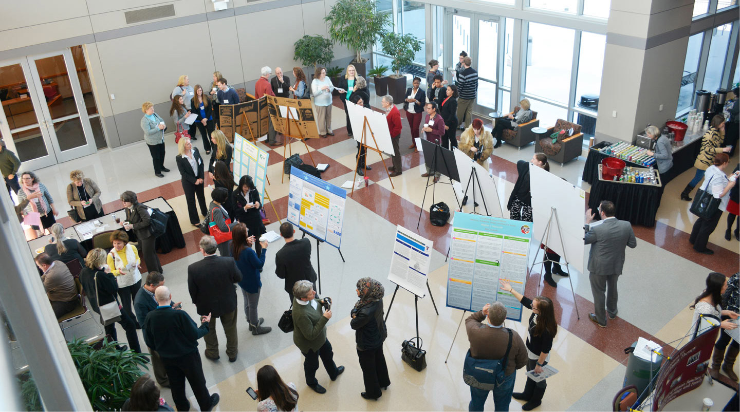 Photo showing attendees viewing posters at the annual IAMFT conference