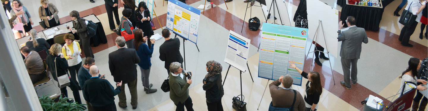 Photo showing attendees viewing posters at the annual IAMFT conference